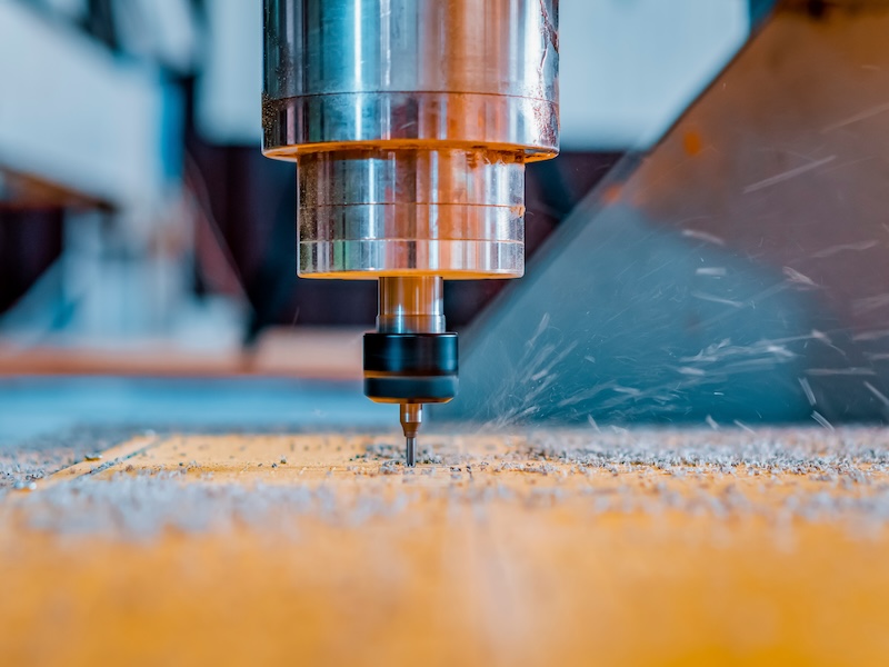 Turning and milling machine with CNC. Closeup of a spindle with a cutter during milling of the workpiece.